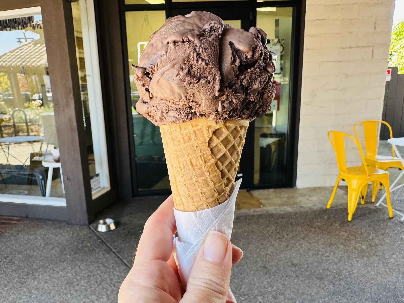 A chocolate chip ice cream cone outside an ice cream shop. The photo was not taken in Sandy Springs.