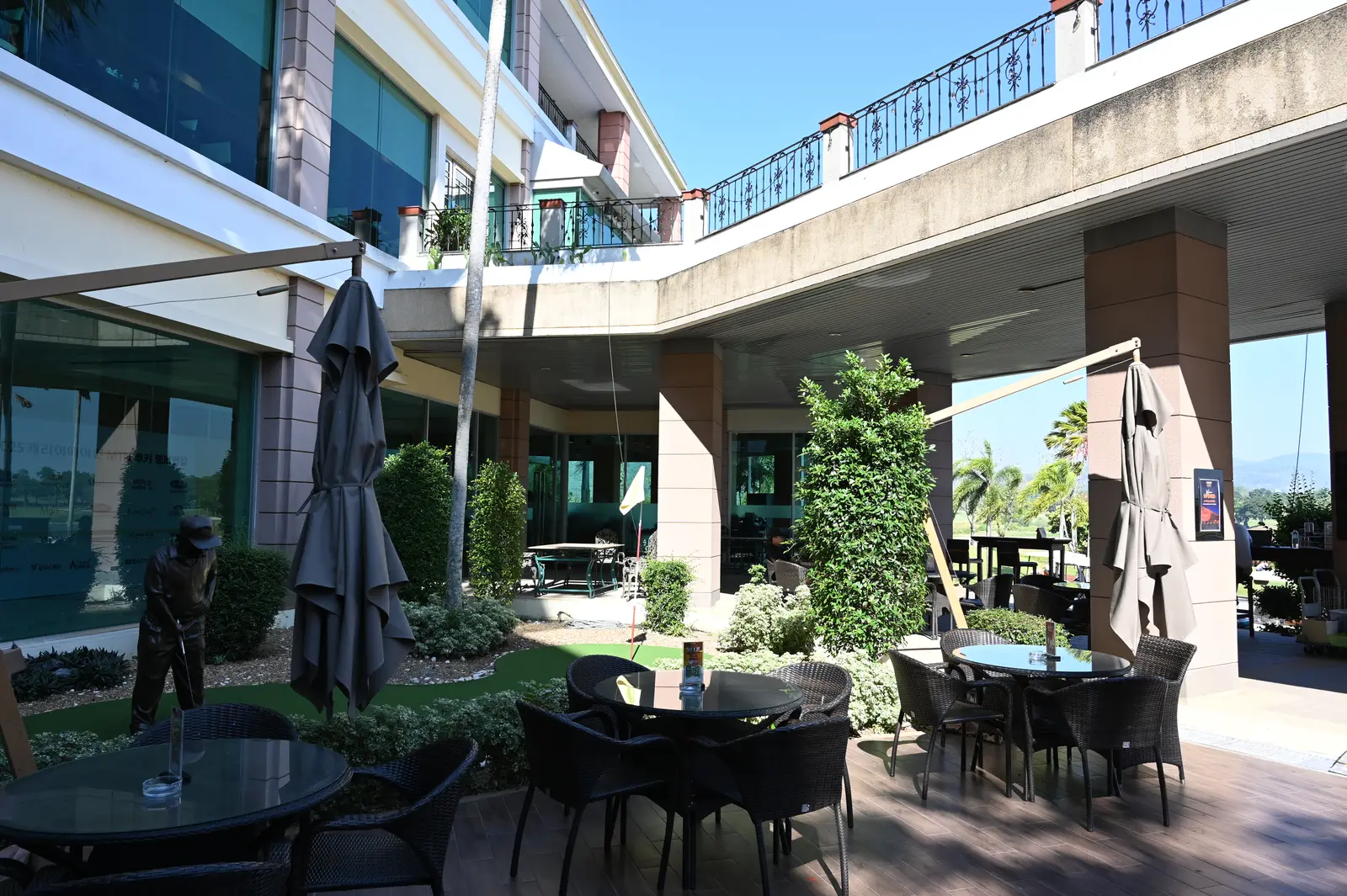 Tables and umbrellas on a cafe patio. The photo was not taken in Sandy Springs.
