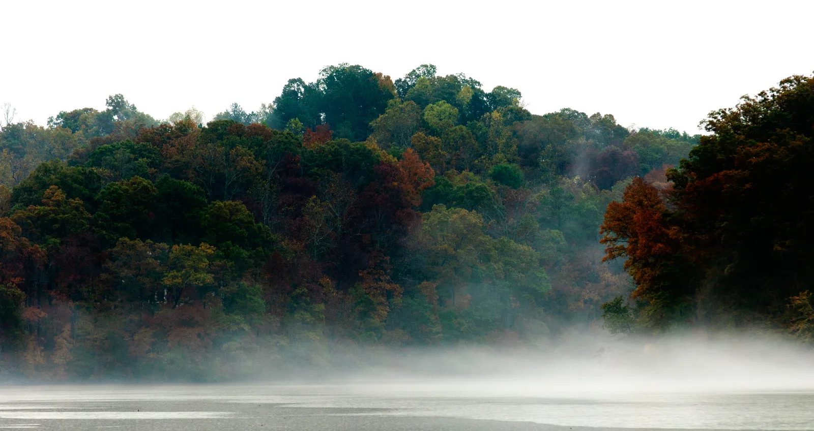 Mist over Bull Sluice Lake on the Chattahoochee River beside Morgan Falls Overlook Park, where the Morgan Falls Connector ends.