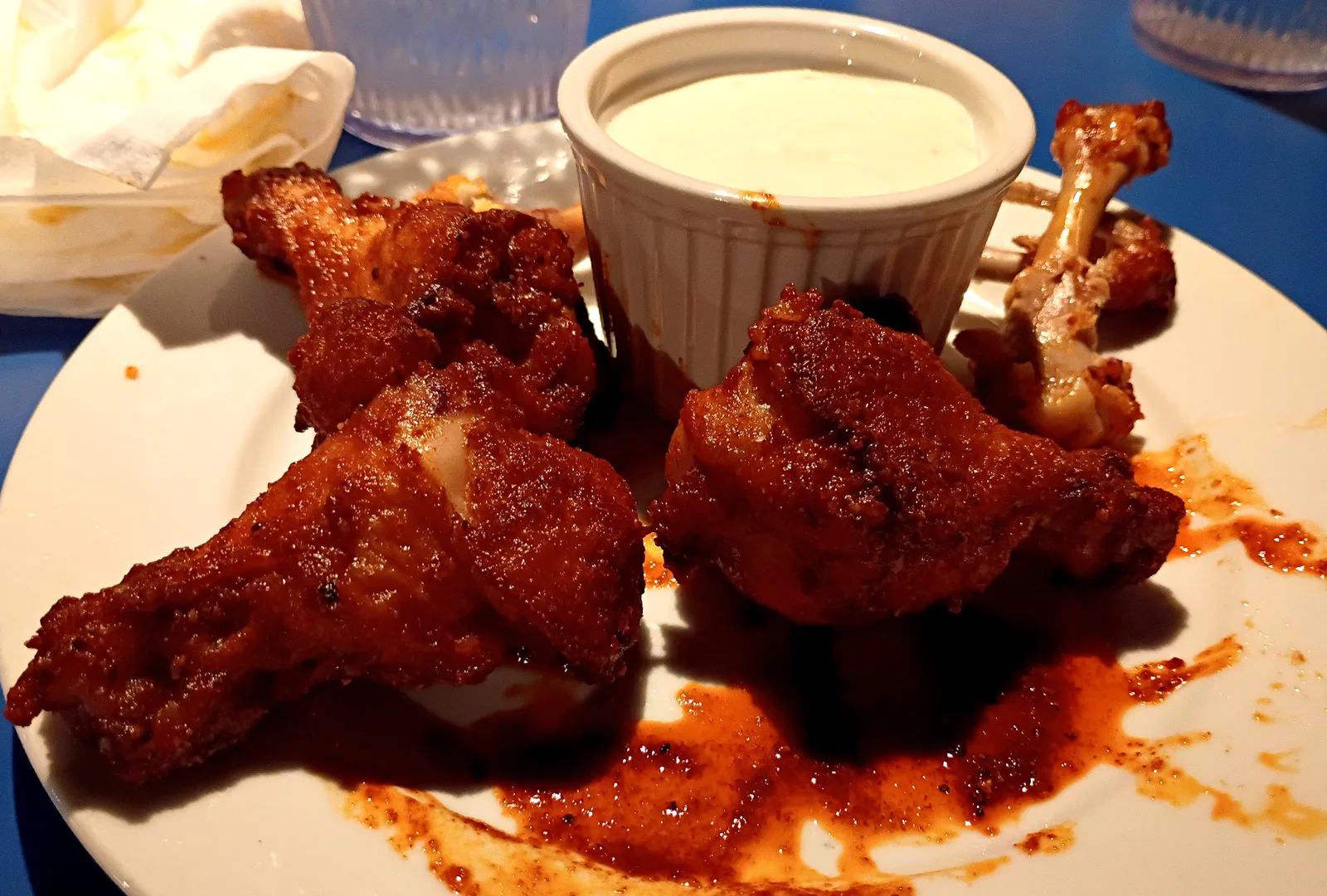 A plate of chicken wings with a dip. The photo was not taken at a Sandy Springs restaurant.